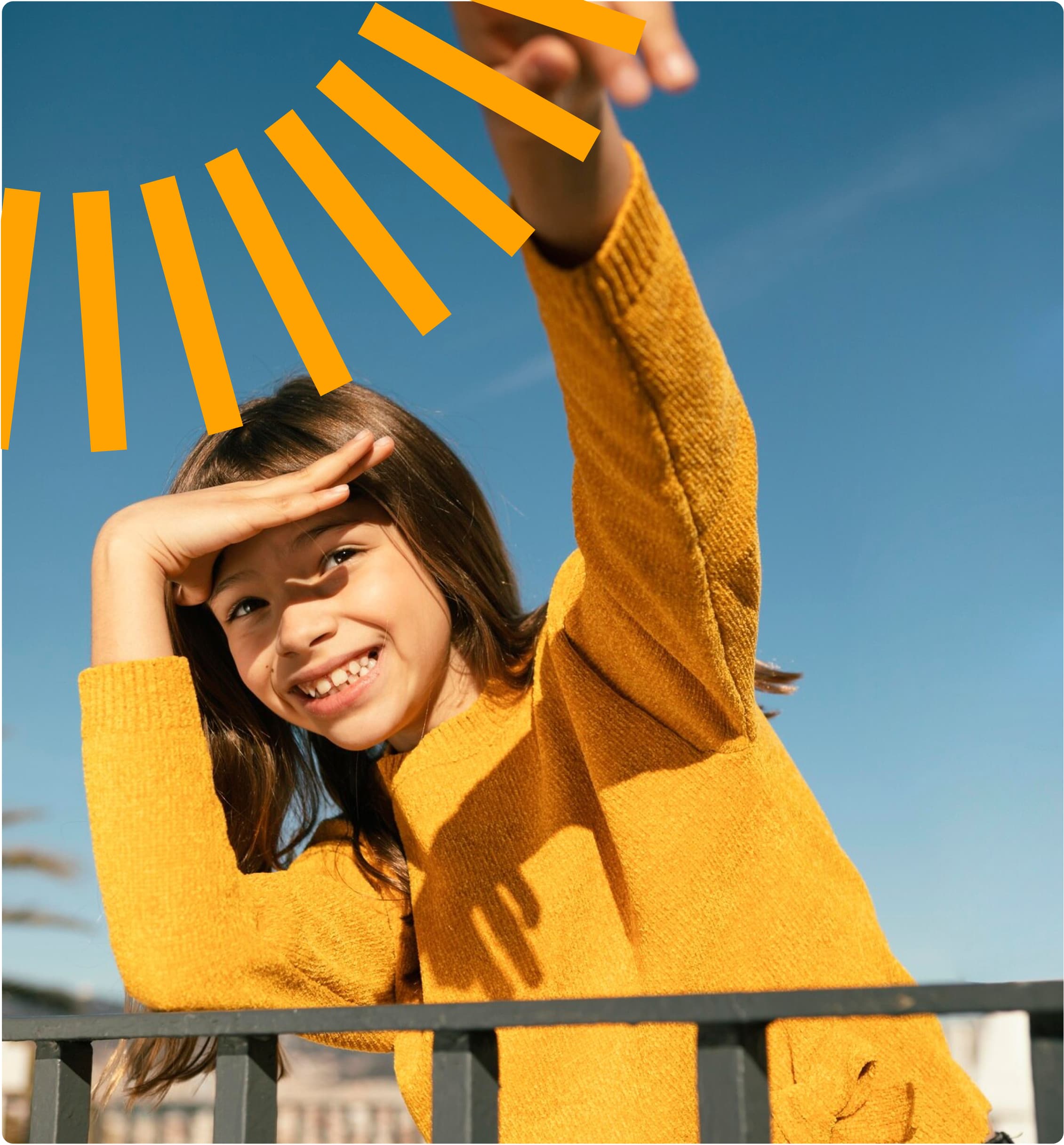 A cheerful child wearing a bright yellow knit sweater shields their eyes from the sun against a vibrant blue sky background, standing by a railing on a sunny day. Decorative orange sun rays appear in the corner of the image.