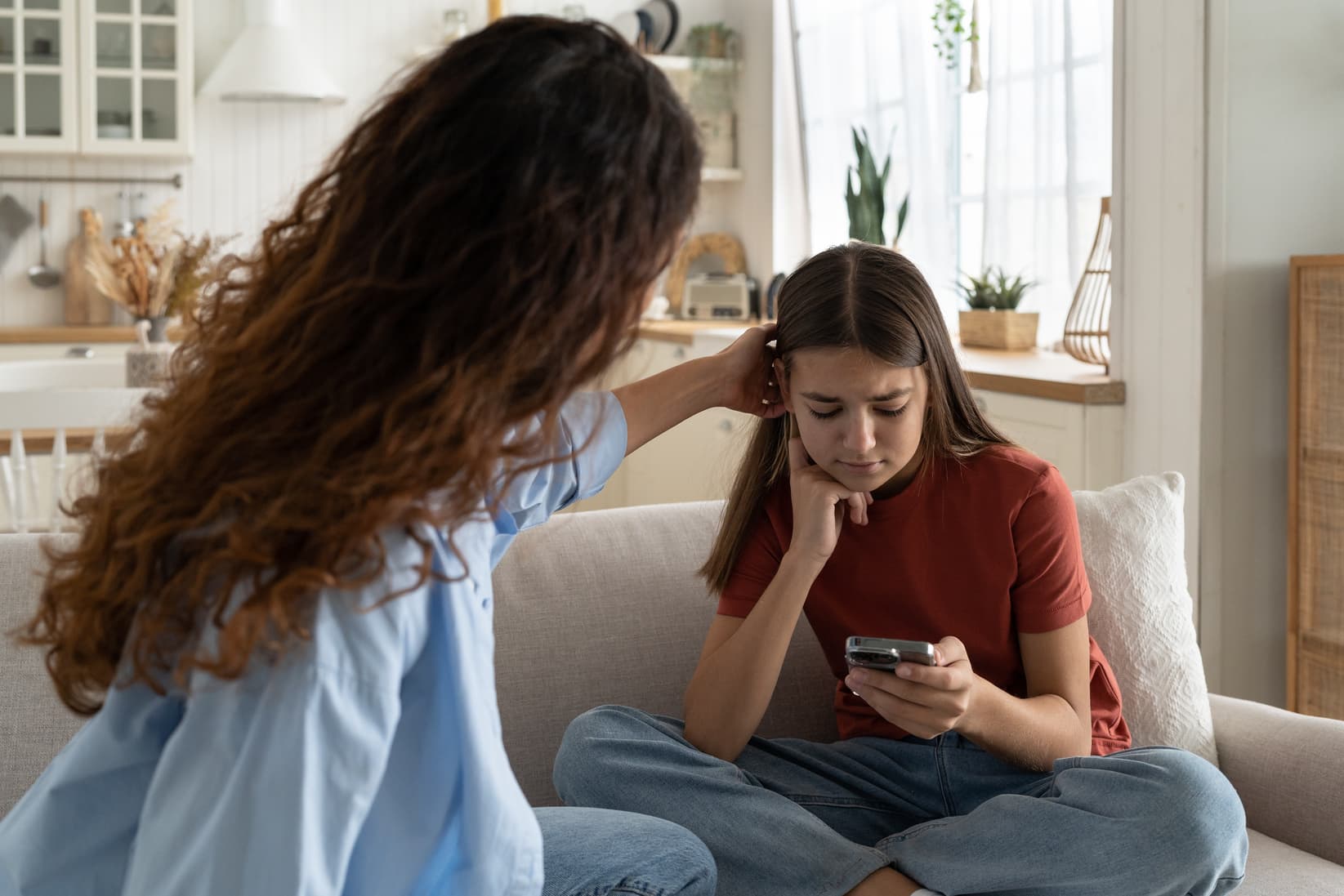 Supportive mother comforting sad teenage girl rejected by friends, helping depressed teen daughter to deal with breakup.